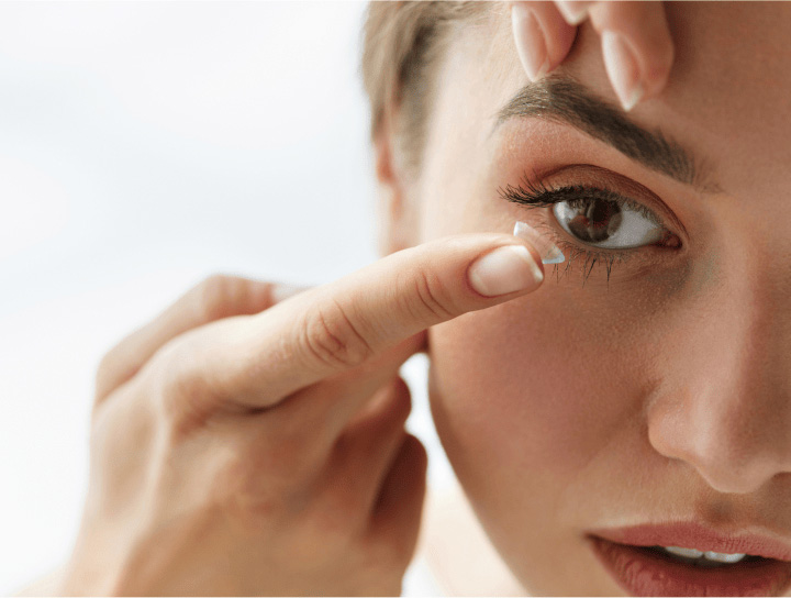 Woman fitting out a contact lens from Family Vision Optical