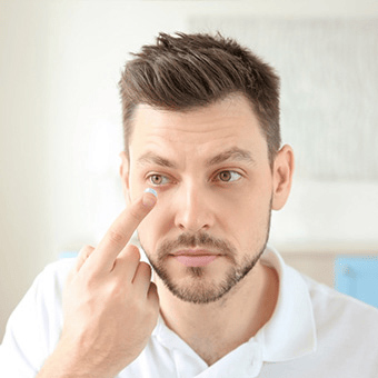 Man putting on his contact lens at FVO