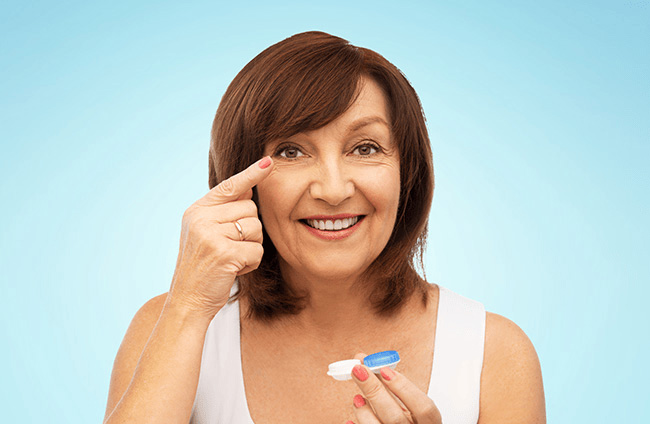 Middle-age woman putting on her contact lens at FVO