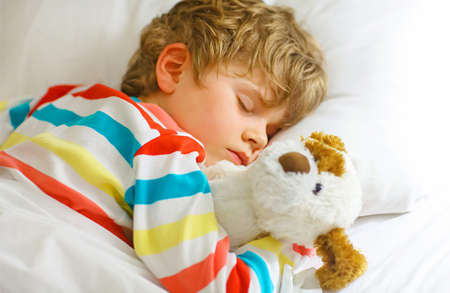 Young child sleeping in bed