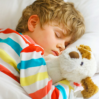 Young kid sleeping in bed