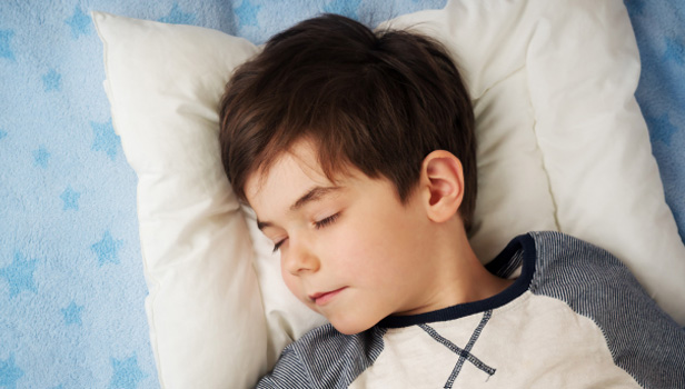 Boy sleeping while wearing Ortho-K lenses to control myopia
