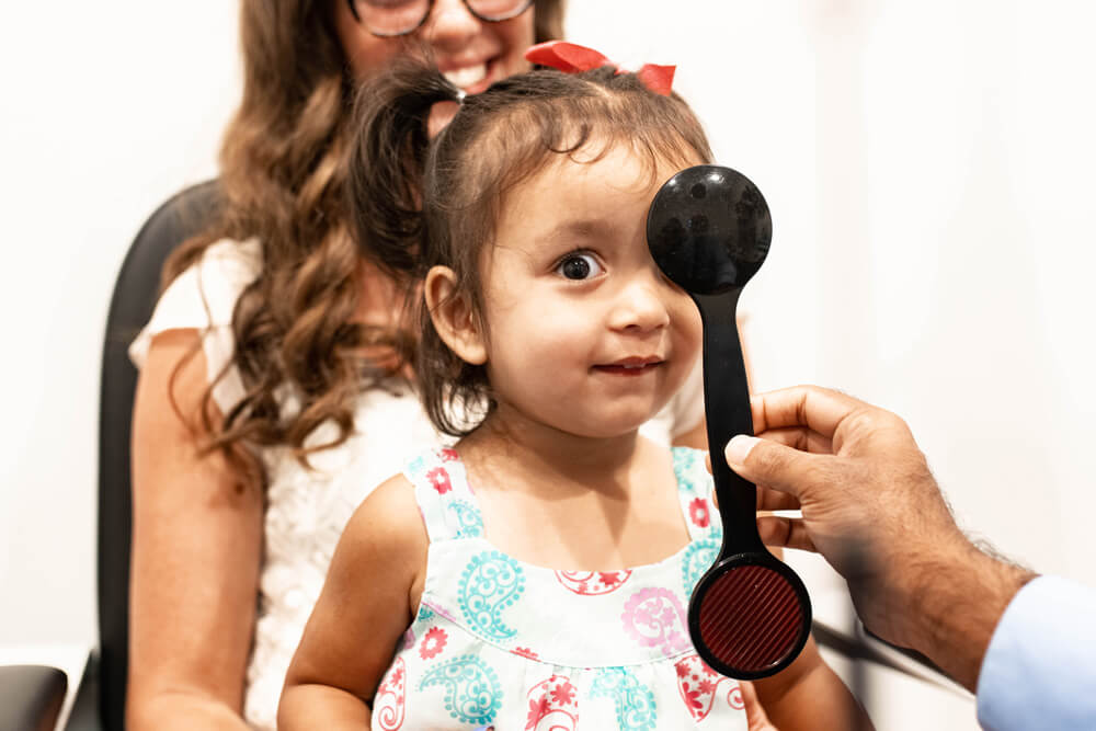 Child getting a pediatric eye exam at Family Vision Optical