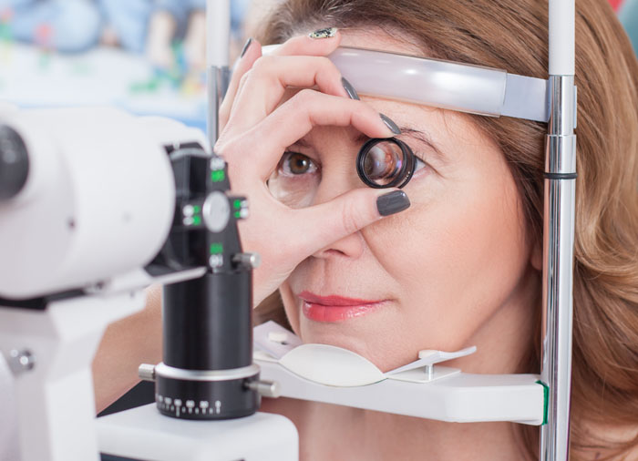 Woman getting an eye exam for AMD at Family Vision Optical in Allendale, MI