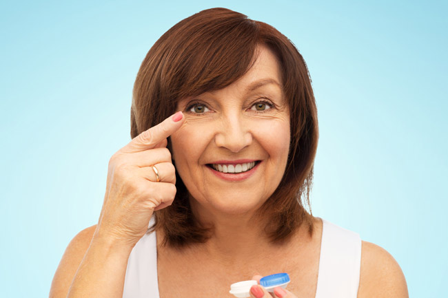 Woman putting in multifocal contact lens