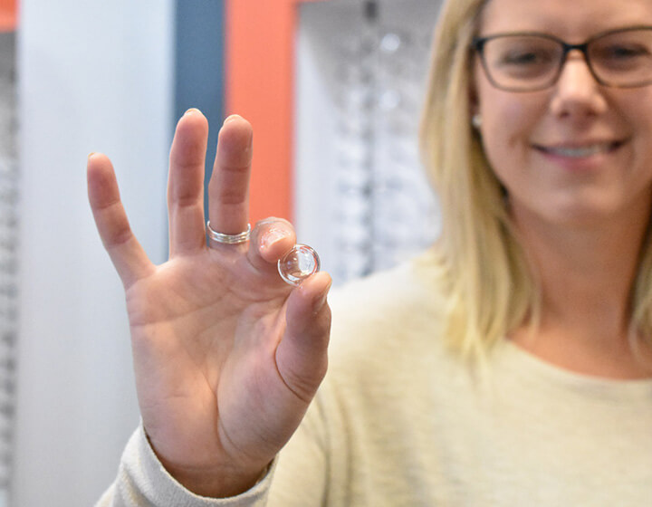 Woman holding scleral lens FVO