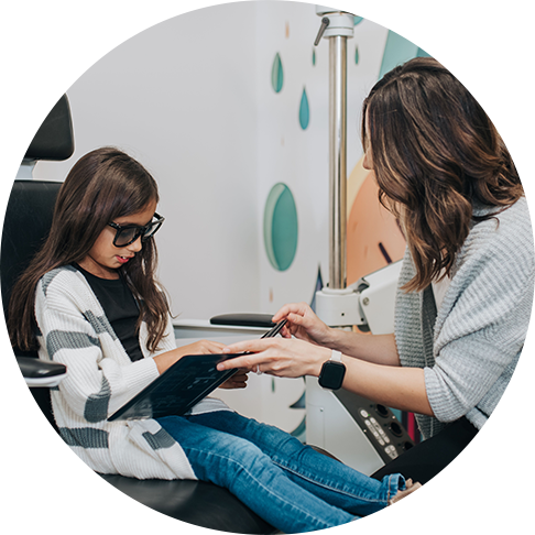 Young girl getting a pediatric eye exam at FVO in Allendale, MI